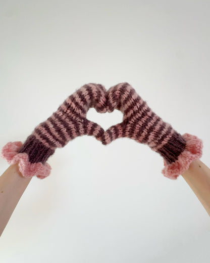 Pair of pink and chocolate striped mittens with frill cuffs on a white background