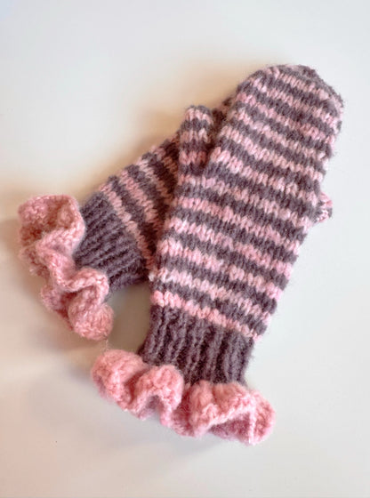 Pair of pink and chocolate striped mittens with frill cuffs on a white background