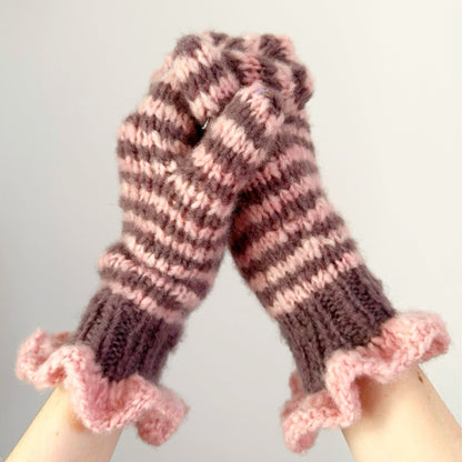 Pair of pink and chocolate striped mittens with frill cuffs on a white background